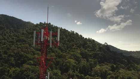 Aerial-drone-orbit-left-shot-of-telecommunications-tower-on-a-tropical-Island-in-Thailand