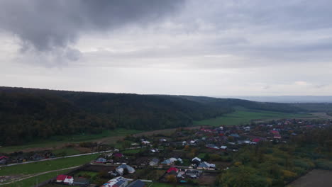 Hyper-lapse-under-low-rain-clouds-over-small-rural-mountain-village-before-storm