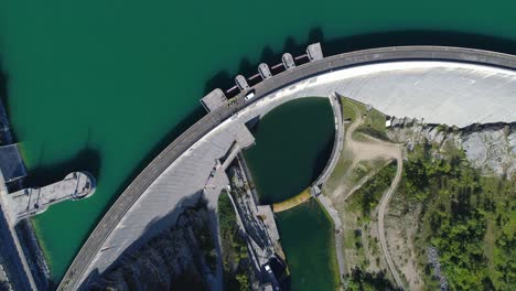 Drone-bird-eye-view-of-the-two-sides-of-a-dam-in-summer