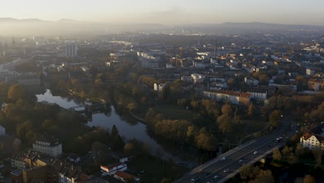Drone-shot-of-the-cityscape-landscape-of-Kassel-in-beautiuful-soft-sunlight-and-covered-in-fog