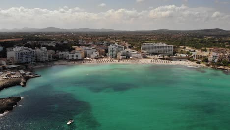 Retreating-aerial-of-clear-water-off-Cala-Moreia-of-S'illot,-Mallorca
