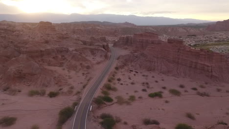 Aerial---Road-between-the-mountains-at-dawn,-Cafayate,-Argentina,-wide-shot