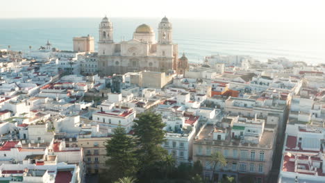 Aerial---Cadiz-Cathedral-in-Cadiz,-Andalusia,-Spain,-rising-wide-shot-overhead