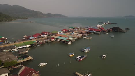 Aerial-pan-to-the-right-of-the-Bang-Bao-fishing-pier-in-Koh-Chang,-Thailand