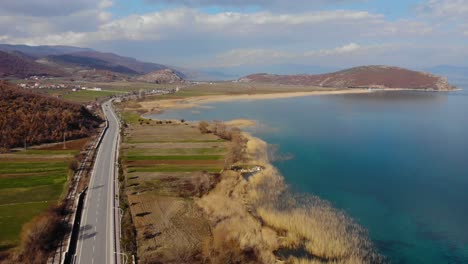 Beautiful-lake-shore-with-colorful-land-and-panoramic-road-on-a-Spring-cloudy-day