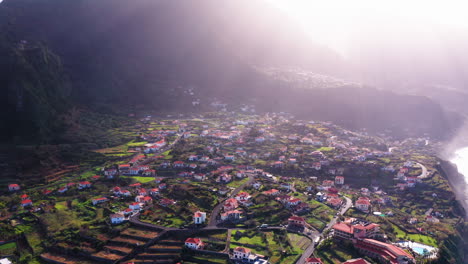 Aerial-view-of-Ponto-Delgada-lighting-with-gigantic-mountain-in-background
