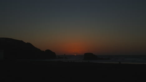 Time-lapse-of-sunset-behind-Chapel-Rock-at-Perranporth-Beach