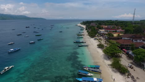 aerial-view-of-Gili-Trawangan-Island,-lombok,-Indonesia,-fisherman-boat-along-the-pristine-blue-ocean-water,-paradise-reosrt-luxury-hotel-ready-for-re-open-for-tourism-industry