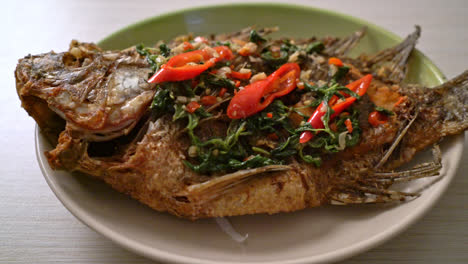 Fried-Tilapia-Fish-with-Basil-chili-garlic-sauce-on-top---homemade-food-style