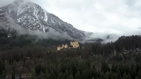 Aerial-view-of-Hohenschwangau-Castle-on-foggy-winter-day