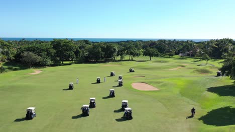 aerial-view-of-golfers-racing-to-reach-the-final-hole-at-a-country-house-located-in-la-romana