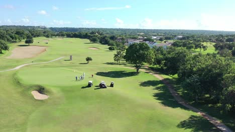 aerial-view-of-golfers-racing-to-reach-the-final-hole-at-a-country-house-located-in-la-romana