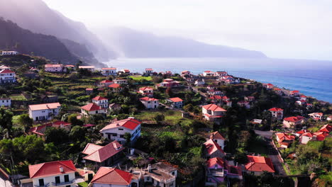 Aerial-view-showing-rural-coastal-village-with-beautiful-ocean-view-during-sunlight