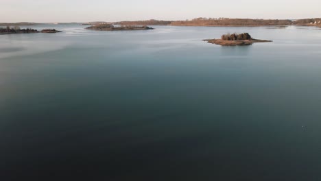 Aerial-shot-of-a-lake-in-Cohasset-during-the-day---4K