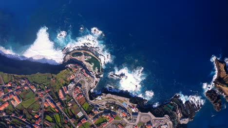 Aerial-top-down-view-showing-blue-Atlantic-Ocean-and-beautiful-landscape-of-Porto-Moniz-on-Madeira-Island-during-sun
