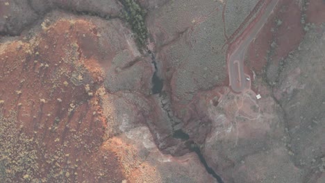 Aerial-orbit-shot-Over-big-Canyon-In-Karijini-National-Park-with-large-Gorge-and-stream-In-Western-Australia