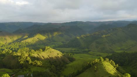 Drone-Flies-Above-Cocora-Valley-in-Salento,-Colombia-during-Sunrise,-Truck-Left