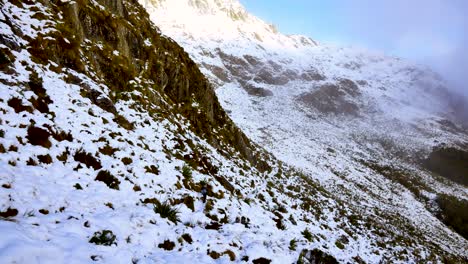 Solo-adventurous-woman,-trekking-the-snowy-steep-mountainous-terrain