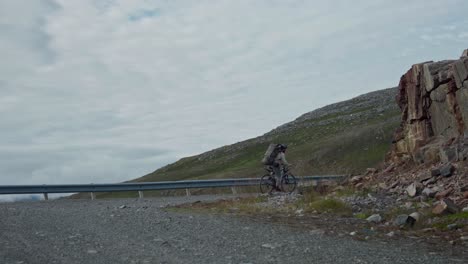 Cyclist-Biking-On-Uphill-Rough-Road-Of-Mountain-In-Norway