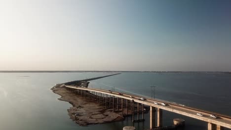 Aerial-drone-view-of-the-JFK-Memorial-Causeway-bridge-and-Laguna-Madre-between-North-Padre-Island-and-Corpus-Christi-Texas-on-a-sunny,-late-afternoon