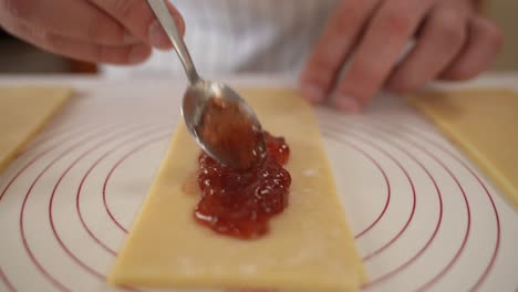 A-chef-puts-strawberry-jam-filling-on-a-handmade-pastry,-gourmet-pop-tarts