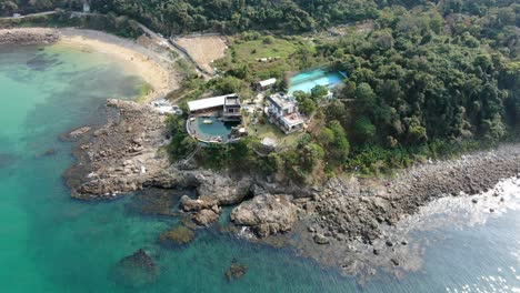 Aerial-view-of-little-palm-beach-villa,-and-a-small-coast-strip-in-Hong-Kong