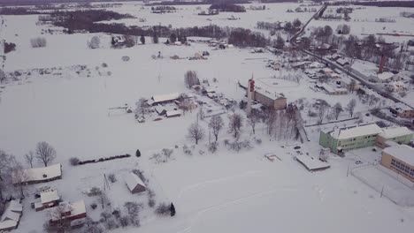 Aerial-View-of-Black-Jeep-Driving-Around-on-Snowy-Field,-Dolly-out