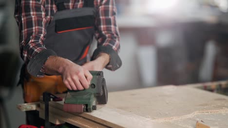 close-up-of-male-hands-working-with-belt-sander