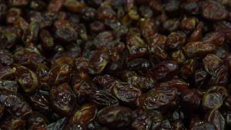 Dried-dates,-fruit,-on-display-at-Nizwa-Souq-marketplace,-Oman,-close-up