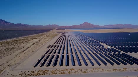 Aerial-side-view-of-Solar-Farm-near-Desert-Mountains