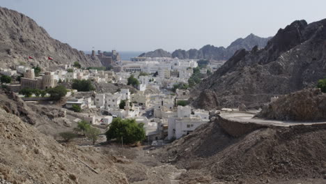 The-Al-Hajar-Mountains-and-Old-Muscat,-Oman,-wide-shot-pan-left