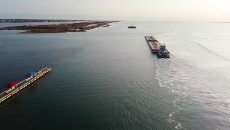 Aerial-view-of-two-large-barges-motoring-along-the-Gulf-Intracoastal-Waterway-in-Laguna-Madre-near-sunset
