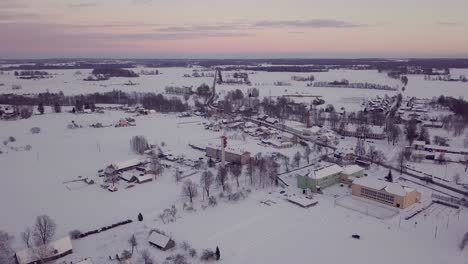 Aerial-Drone-View-of-Countryside-Village-in-Winter-Evening,-Sunset-Colors