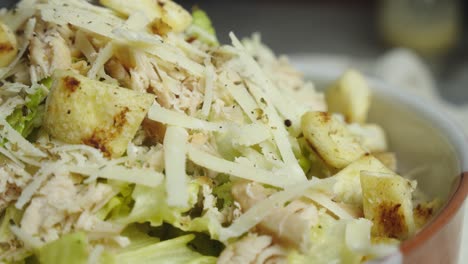 Close-up-on-nicely-plated-caesar-salad-with-shredded-cheese-on-top
