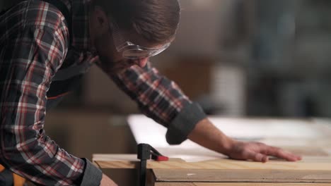 Closeup-portrait-of-carpenter-clamping-carpentry-board