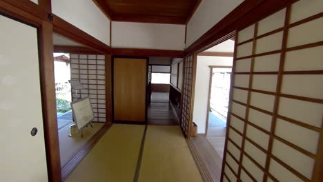 Steadicam-shot-moving-through-hallway-of-a-Japanese-house-into-kitchen-and-up-to-a-mulberry-paper-window