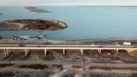 Aerial-view-following-JFK-Memorial-Causeway-connecting-North-Padre-Island-and-Corpus-Christi-over-Laguna-Madre