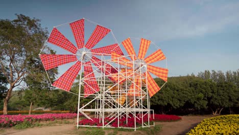 Windmill-art-exhibit-at-Jim-Thompson-Farm,-Thailand,-where-visitors-learn-about-the-culture-of-Thai-Laotian-people-and-gain-awareness-of-the-ancient-and-beautiful-northeastern-culture-and-traditions
