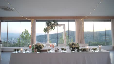 indoor-wedding-reception-venue-with-dining-tables-and-decoration,-wide-dolly