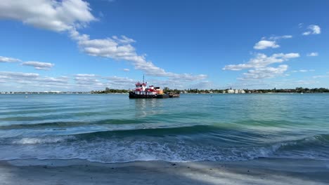 Sarasota,-Florida---December-19,-2020:-A-tugboat-sitting-in-the-clear-blue-water-of-an-inlet-from-the-Gulf-of-Mexico