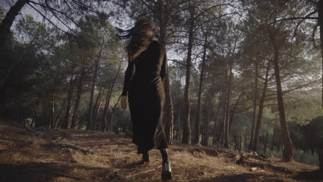 Fashion-model-in-black-walk-of-fame-entering-woods-Spain