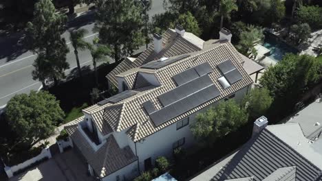 Modern-luxury-house,-residential-neighborhood,-home-with-solar-panels,-aerial-drone-view