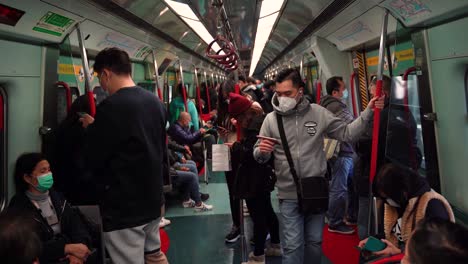 Crowded-Train-With-People-Wearing-Masks-During-COVID-19-Pandemic-in-China,-Hong-Kong