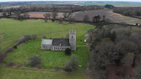 Aerial---St-Mary's-Church-in-Somerleyton,-England,-wide-spinning-shot