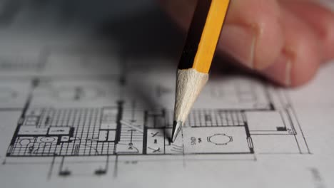 Professional-architect-draws-over-blueprint,-Creative-Designer-reviews-drawings