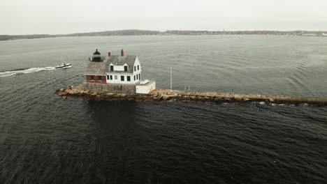 Aerial-Orbit-Drone-footage-of-lighthouse-on-the-breakwater-at-Rockland,-Maine,-USA