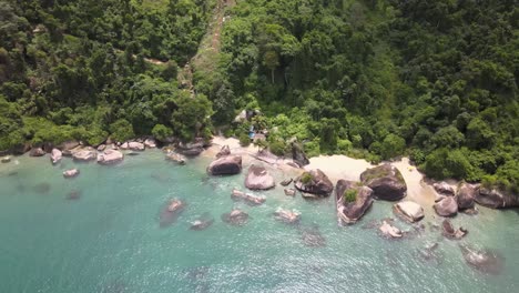 Panoramic-of-the-perfect-composition-between-the-turquoise-sea,-giant-rocks-and-Atlantic-forest-in-Angra-do-Reis,-Rio-de-Janeiro,-Brazil