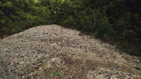Aerial-tilt-down-footage-of-Land-fill-garbage-dump-in-the-middle-of-the-rain-forest-in-Thailand