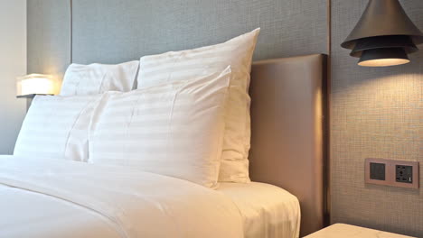 Pan-from-the-wall-to-the-pillows-of-a-big-comfortable-bed-in-a-hotel-suite