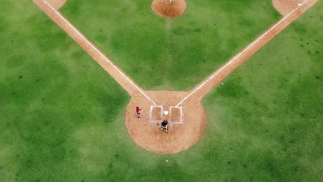 San-pedro-de-macoris,-DR---March-12,-2021---aerial-view-drone-young-people-playing-baseball-at-stadium-in-san-pedro,-training-session